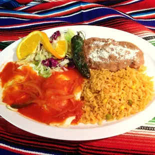 Breakfast over easy eggs with rice and beans.