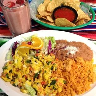 Huevos a la Mexicana with rice and beans. Fresh shake and chips.
