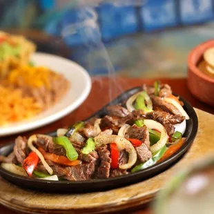 a plate of beef and peppers