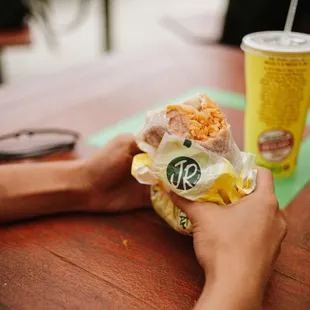 a person holding a bag of food