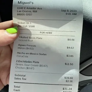 a person holding a receipt in their hand