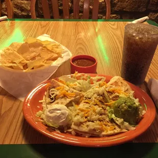 a plate of mexican food and a drink