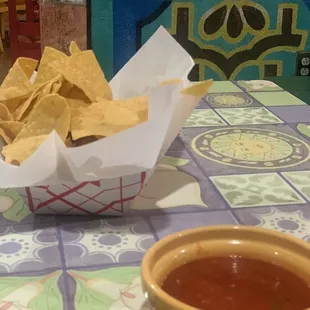 a bowl of chips and a bowl of salsa