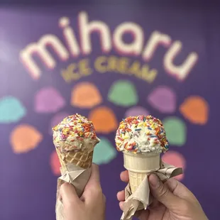 two ice cream cones with sprinkles