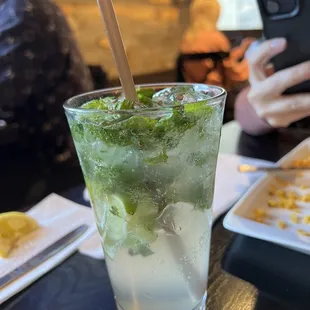 a mojit in a glass with a straw