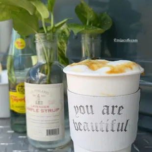 Hot Caramel Latte with propagated pothos in the background.