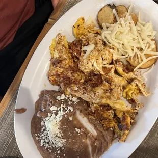 Breakfast platter with eggs and chorizo, tortillas on the side
