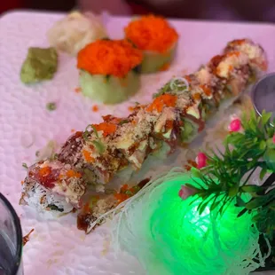 a plate of sushi with a green light