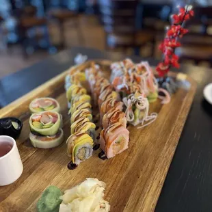 a variety of sushi on a wooden board