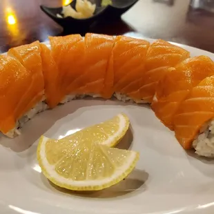 a piece of salmon on a plate with a slice of lemon