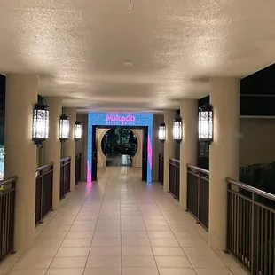 a long hallway leading to a pool