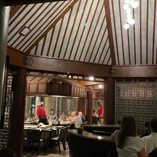 a group of people sitting at a table in a restaurant