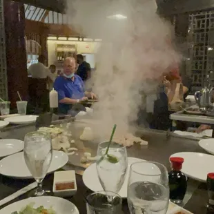 a group of people sitting around a table with food
