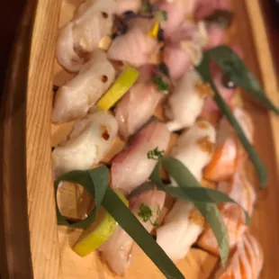 a wooden boat with sushi on it