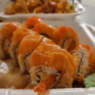 a sushi roll with shrimp and carrots