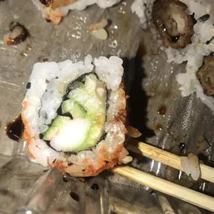 a sushi roll and chopsticks