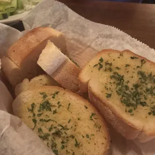 Undercooked garlic bread -the one side is toasted the other side just bread with storage stale/frozen after taste.