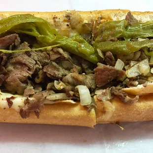 Small cheesesteak with onions and roasted long hots. My mouth is burning, eyes are tearing up and I love it.