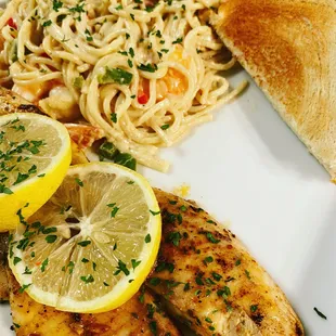 Tilapia and shrimp spaghetti served Texas garlic bread.