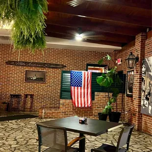Indoor patio complete with ferns, fans, and air conditioning.