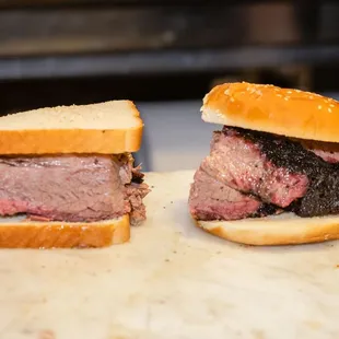 two sandwiches on a cutting board