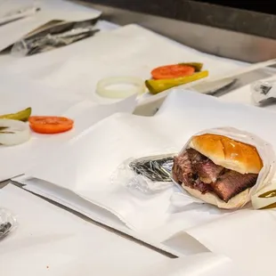 a sandwich with pickles and tomatoes