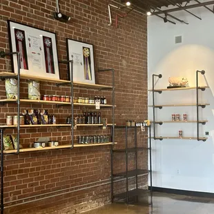 a brick wall with shelves of food