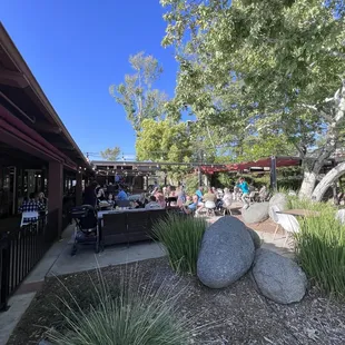 Extensive outdoor patio and dining area with a firepit and bar area