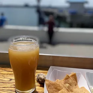 a glass of beer and crackers