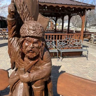 a statue of a man sitting on a bench