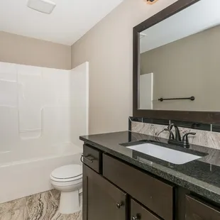 a bathroom with a sink, toilet, and bathtub