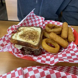 Ribeye sandwich, onion rings, mozzarella sticks