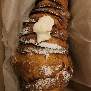 a pastry with icing and powdered sugar