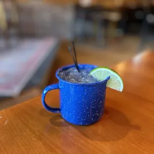 a blue mug with a lime slice