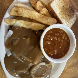 Smothered chop steak gravy and onions with steak fries with a extra side of bbq beans.