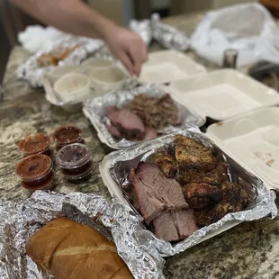 Feast of meats, Cole slaw, baked beans, bread and sauces
