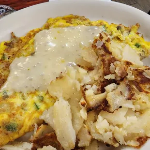 an omelet with potatoes and gravy