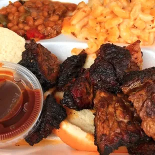 a plate of ribs, macaroni and cheese