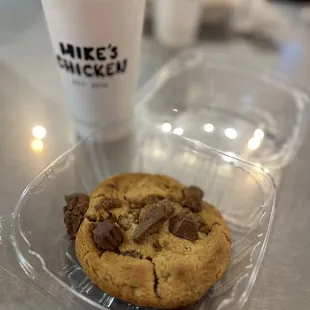 a chocolate chip cookie and a cup of coffee