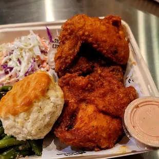 Half a spicy fried chicken with green beans and slaw