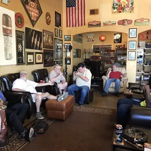 a group of men sitting in leather chairs