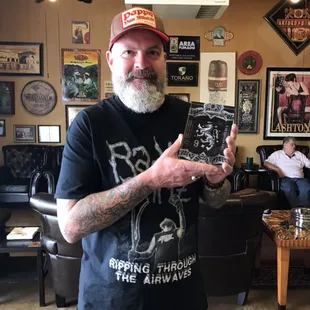 a bearded man holding a book
