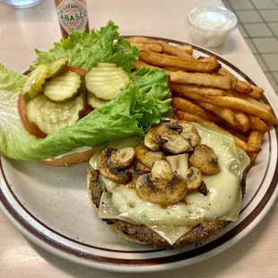 a mushroom cheeseburger and fries