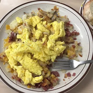 a plate of scrambled eggs and potatoes