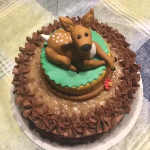 3 inch Resting fawn cake topper on a 6 inch German Chocolate baby cake frosted in chocolate buttercream.