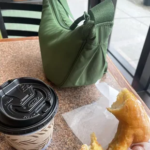 small hot coffee and glazed donut