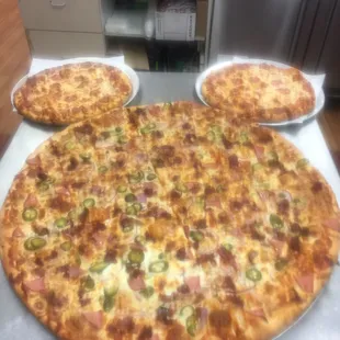 A giant Mexican pizza and two large pepperoni&quot;s put together for the Mickey mouse logo