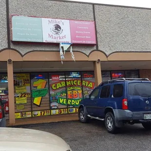two cars parked in front of the store