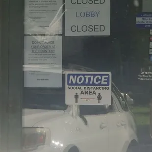 a car parked in front of a closed sign