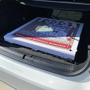 Giant Pepperoni pizza in trunk of car